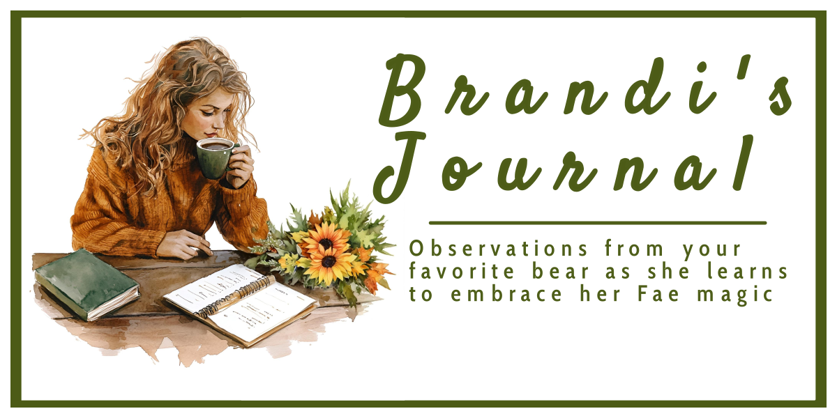 woman with brown hair wearing a dark orange colored sweater and holding a cup of coffee while sitting at a wooden desk and writing in a journal